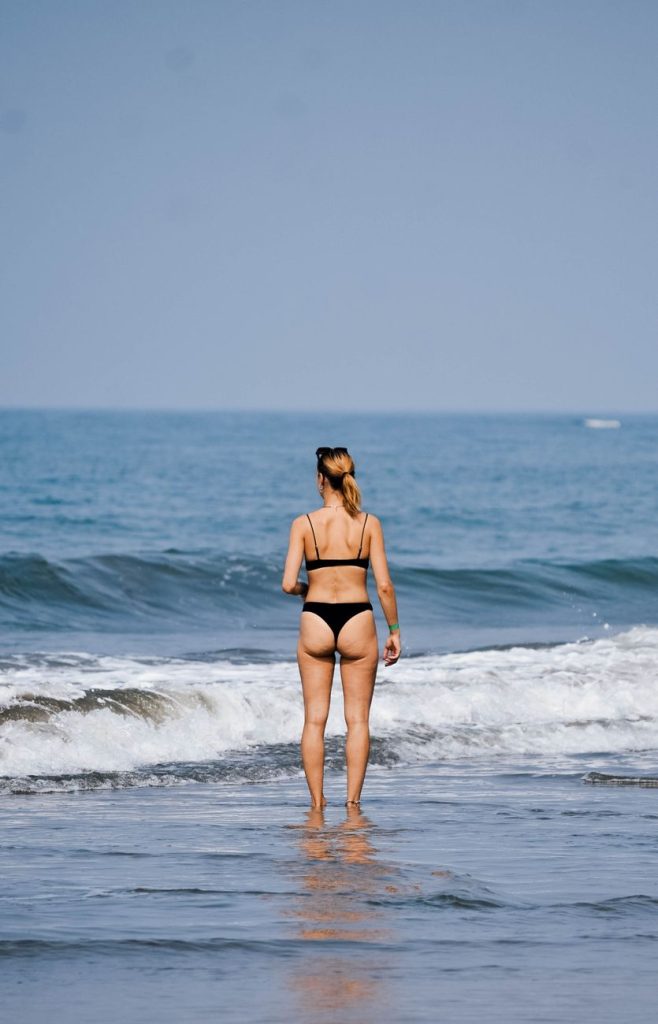 Woman in a bikini by the water